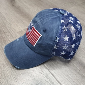Detail der US-Flaggenstickerei und weißer Sterne auf der blauen Mesh-Trucker-Mütze