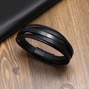 Multi-layer black braided leather bracelet with magnetic buckle and metal plate on wood