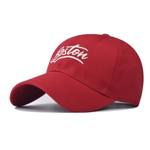 Close-up of white Boston embroidery on a classic red cotton baseball cap detail