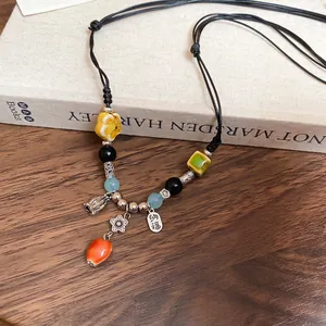 Ethnic retro ceramic beaded necklace with silver flower charms and blessing tag