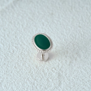 Detailed macro view of 925 silver flat back stud with green oval stone and bead edging