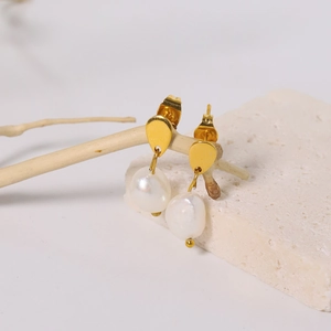 Elegant gold titanium steel earrings featuring irregular pearls on a minimalist stone base