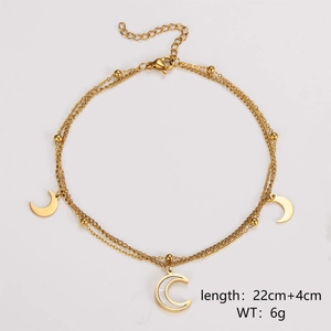 Detail of double-layer gold anklet featuring moon charms and 22cm plus 4cm extension