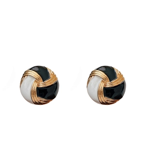 Vintage round black and white button stud earrings with golden metallic accents