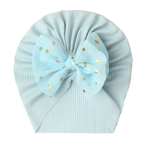 Light blue ribbed baby turban hat featuring a large gold polka dot chiffon bow