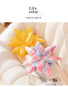 Close-up of colorful succulent plush pillow with petal details on a white sofa