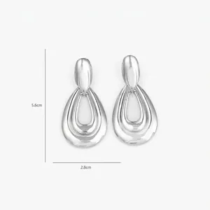 Detailed view of large teardrop earrings with silver-polished nested streamlined layers