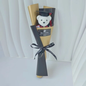 Detail view of graduation plush bear with sunflower soap bouquet in black and gold wrap