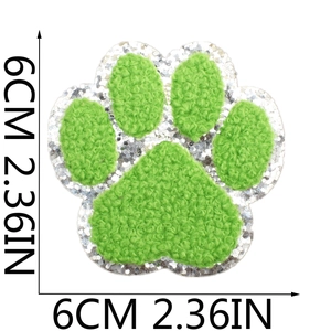 Detail view of 6cm green chenille paw patch with silver glitter edge for DIY clothing