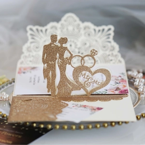 Golden glitter wedding invitation card with Mr & Mrs cutout and romantic silhouette
