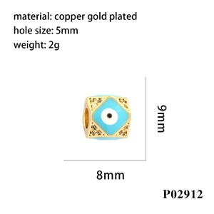 Macro detail of a 9x8mm copper gold-plated evil eye bead showing size and 5mm hole specifications