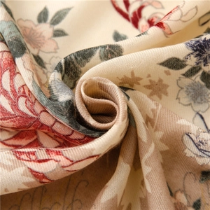 Detailed view of vintage floral print on beige linen-feel fabric with twill texture