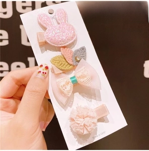 Detail of 4-piece set including cute glitter bunny, floral, and leaf cloth hair clips