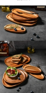 Detailed view of oval acacia wood trays showing natural grain textures and rounded edges