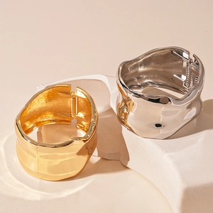Irregular wrinkled metal wide bangle set in gold and silver finish with spring closure