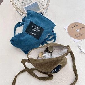 Flat lay of vintage corduroy crossbody bags with canvas lining and artistic labels