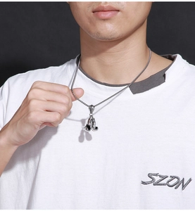 Male model wearing silver boxing glove pendant necklace with stainless steel box chain