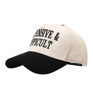 Retro baseball cap with beige crown, black brim, and bold letter embroidery