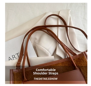 Detail of the brown plush and leather tote bag featuring slim shoulder straps and large capacity