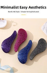 Detail of four colorful glittery detangling hairbrushes in purple red blue and grey colors