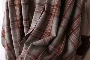 Close-up of soft brown and beige plaid pattern cashmere-like fabric scarf texture