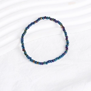 Detailed close-up of bohemian beaded bracelet featuring metallic blue and purple beads