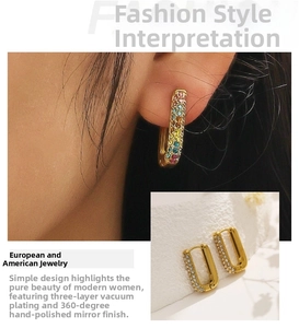 Macro detail of 18k gold plated U-shaped earrings with colorful and white zirconia stones