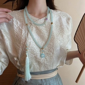 Detail of light blue beaded tassel necklace with a ring pendant for Hanfu clothing