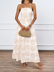 Detail of white halter neck dress with light brown tropical palm leaf print pattern