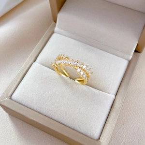 Adjustable gold plated crossover ring featuring marquise cut sparkling zircons