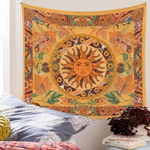 Detail of tarot tapestry with sun and zodiac motifs hanging as bedroom wall decor