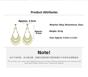 Detail view showing dimensions of vintage tassel earrings with green crystals and rhinestones
