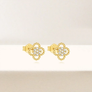 Macro view of gold clover stud earrings with S925 sterling silver hallmarked backings