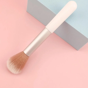 Detail of soft synthetic fiber bristles on a portable white blush makeup brush