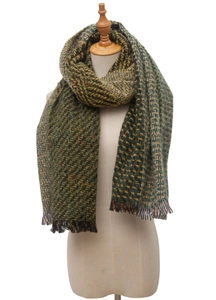 Close-up of woven scarf texture with green and yellow herringbone pattern and fringe edges