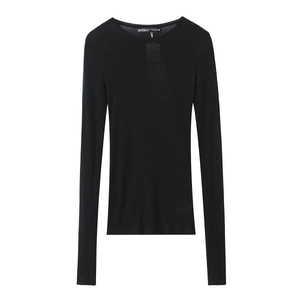 Close-up of the brand label and crew neckline on a slim-fit black long-sleeve cotton T-shirt