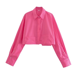 Detail of rose pink cropped shirt featuring classic collar and front double pockets