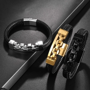 Detailed shot of three woven leather bracelets with silver gold and black metal buckles