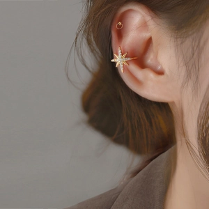 Sparkling zircon star ear cuff in gold finish worn by a model for a chic minimalist style