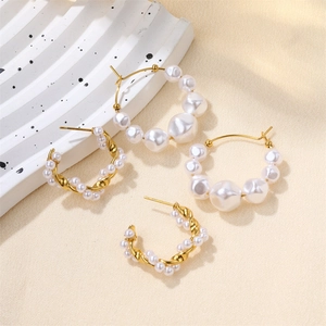 Detailed macro view of gold-plated titanium earrings with elegant freshwater pearls