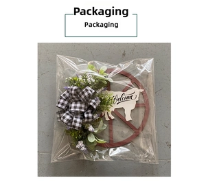 Detail of rustic cow and wheel wreath with Welcome sign in clear packaging