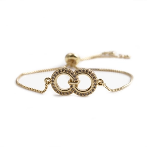 Adjustable gold woven bracelet with interlocking micro-pave cubic zirconia circles