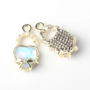 Detailed close-up of heart charm with blue resin inlay and elegant pearl butterfly bow