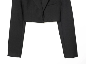 Detail shot of black cropped blazer showing premium twill fabric texture and collar stitching