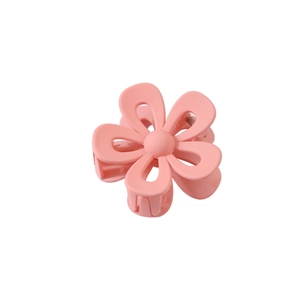 Detailed macro view of pink matte flower hair claw clip with sturdy metal spring mechanism