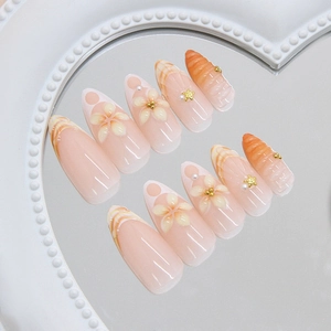 Floral ocean theme press-on nails with orange gradient, starfish and pearl accents