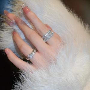 Detail of silver double-layered open ring with pearl and zircon on white fur