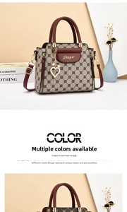 Detail showing elegant handbag with LX pattern, burgundy leather trim and gold accessories