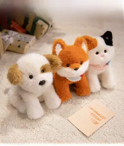 Detailed view of plush cat and fox toys with soft fur and plaid scarves on a cozy rug