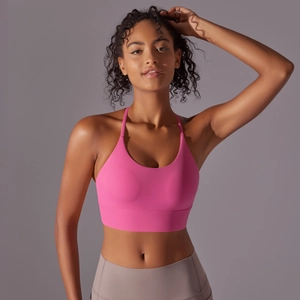 Detail of pink halter neck sports bra with wide elastic band and moisture-wicking fabric